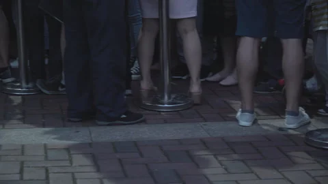 2019 Jun 08, Jiaxing. Low angle close-up of peoples feet and lower legs waiting Stock Footage 345137437
