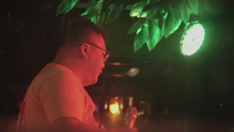 2019 Jun 08, Jiaxing. Man with glasses holding microphone performs Stock Footage 345515891