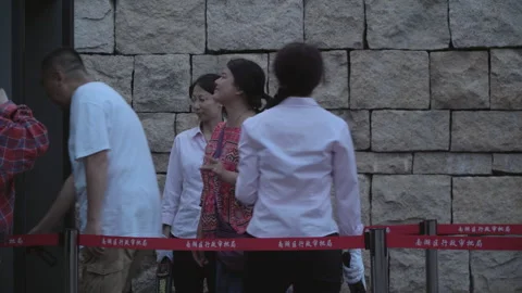 2019 Jun 08, Jiaxing. People queue orderly behind red barriers 스톡 동영상 345136805