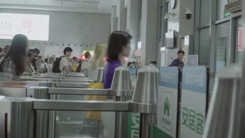 2019 Jun 09, Jiaxing. Passengers move through turnstiles Stock Footage 345724952