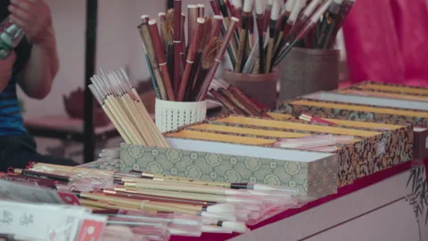 2019 Jun 09, Jiaxing. Vendor displays assorted calligraphy brushes Stock Footage 345586595