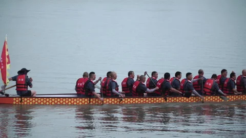 2019 Jun 10, Jiaxing. Crew paddles red dragon boat on calm river Stock Footage 338283063