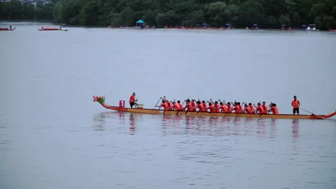 2019 Jun 10, Jiaxing. Dragon boat team paddles across calm lake in race Stock Footage 336313282
