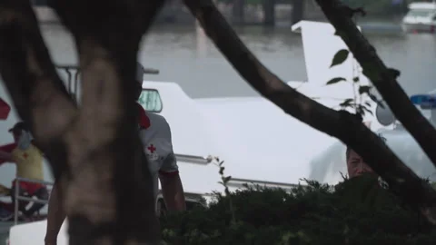 2019 Jun 10, Jiaxing. Red Cross Workers Near Seaplane at Waterfront Stock Footage 338286322