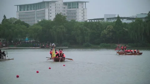 2019 Jun 10, Jiaxing. Rowing teams race wooden boats on urban lake Stock Footage 338290287
