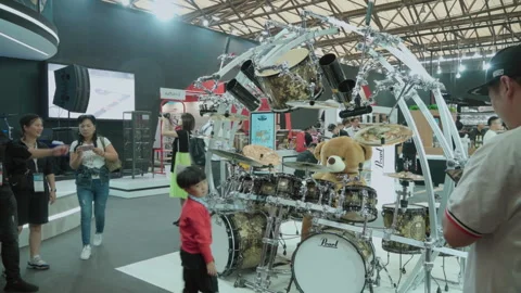 2019 Oct 13, Shanghai. Attendees browse a custom Pearl drum kit display Stock Footage 345922079