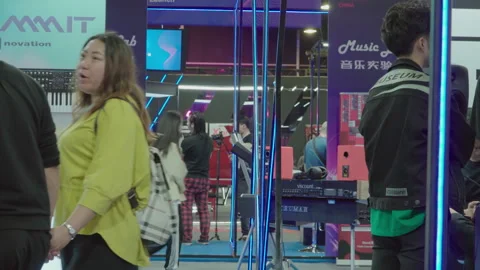 2019 Oct 13, Shanghai. Attendees browse electronic musical equipment Stock Footage 345931831