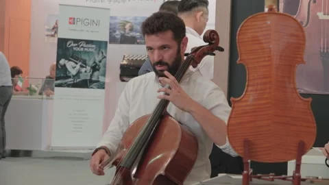 2019 Oct 13, Shanghai. Bearded cellist prepares to play Stock Footage 345929289