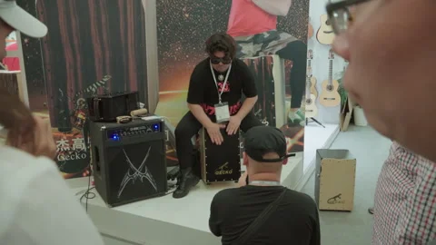 2019 Oct 13, Shanghai. Man demonstrates Gecko cajon drum Stock Footage 345923974