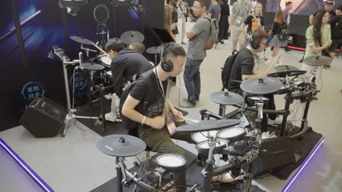 2019 Oct 13, Shanghai. Men play and test electronic drum kits Stock Footage 345917798