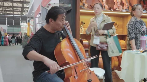 2019 Oct 13, Shanghai. Middle-aged man playing cello Stock Footage 345928677