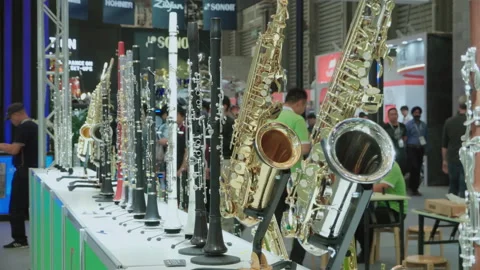 2019 Oct 13, Shanghai. Polished wind instruments on display Stock Footage 345925086