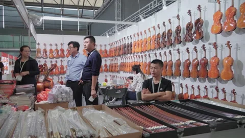 2019 Oct 13, Shanghai. Violin exhibitors at the musical instrument exhibition Stock Footage 345929453