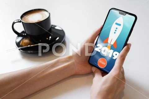 2019 year Rocket start button on mobile phone screen. Business concept. Stock Photos