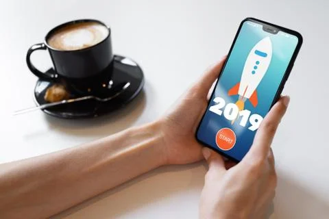 2019 year Rocket start button on mobile phone screen. Business concept. Stock Photos