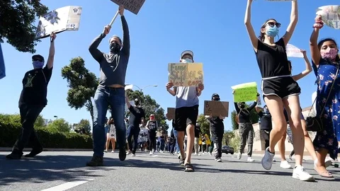 2020 - extreme slo mo marching protesters during a Black Lives Matter BLM march Stock Footage 132444060