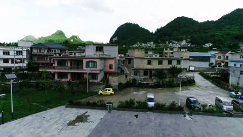 2020 Jun 01, Guizhou. Man Shooting Basketball on Outdoor Court Near Pink House 스톡 동영상 335773265