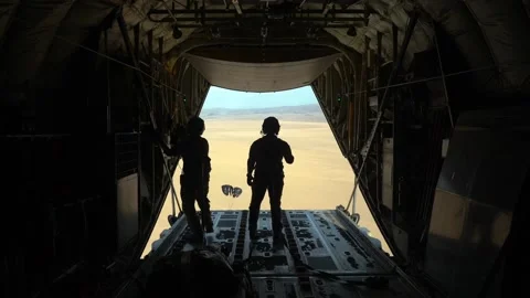 2020 U.S. Air Force crewmen drop parachute bundles over the desert from a C-130J Stock Footage 152617481