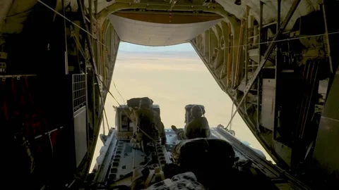 2020 U.S. Air Force crewmen drop parachute bundles over the desert from a C-130J Stock Footage 152617852