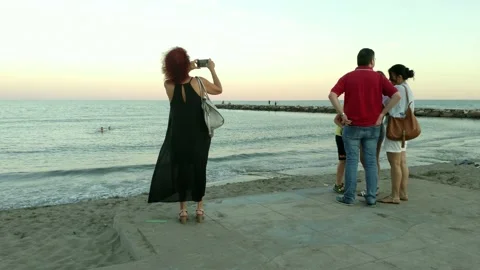 2020_07_04_people_watching_and_filming_the_sea Stock Footage