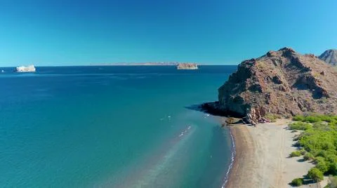 2020:LIGUI BCS MEXICO.Aerial Pan Of Objects Seen In The Distance Behind An Ocean Stock Photos