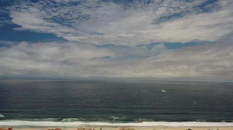 2020:LOS CABOS MEXICO.White Clouds Spread Throughout Blue Sky Over Beach And Stock Photos