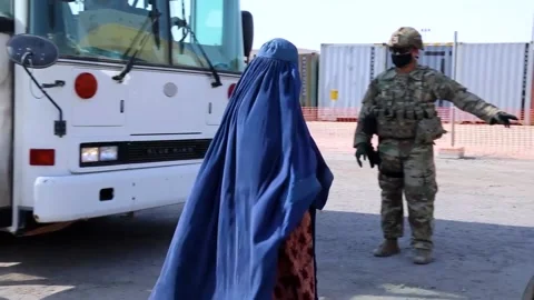 2021 - Afghan refugees make it to safety and are ushered onto planes by U.S. Stock Footage 159811656