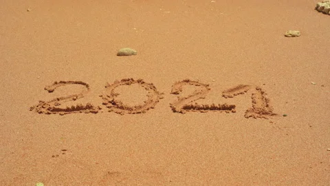 2021 is washed away by the wave. 2020 written on the sand Stock Footage 154653388