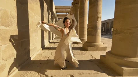2022 - An interpretive dancer performs among the columns of the Philae Temple Stock Footage 232799429