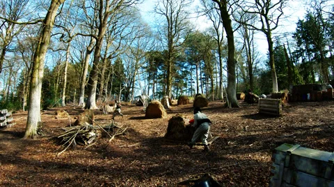 2022 Mar 29 Exeter UK POV paintball player provides cover to his teammates Stock Footage 253999357