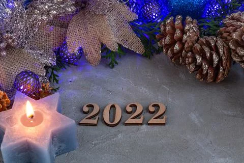 2022, new year composition in silver blue color, blue garland, spruce, candle Stock Photos