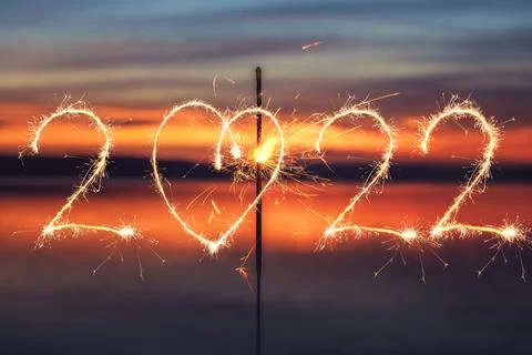2022 written with Sparkle firework on sunset background, happy new year 2022 Stock Illustration