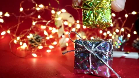 2022 year. Gifts in holiday boxes on the background of LED garlands. Stock Footage 165890053