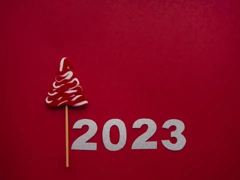 2023 and white red candy in the form of a Christmas tree on a red background Stock Photos