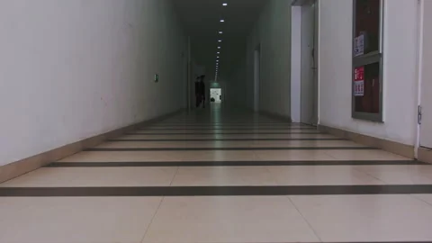 2023 Apr 2. Shanghai, Two people walking in striped corridor Stockbeeldmateriaal 332853027