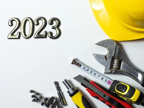 2023 with construction tools, hard hat on white background with copy space Stock Photos