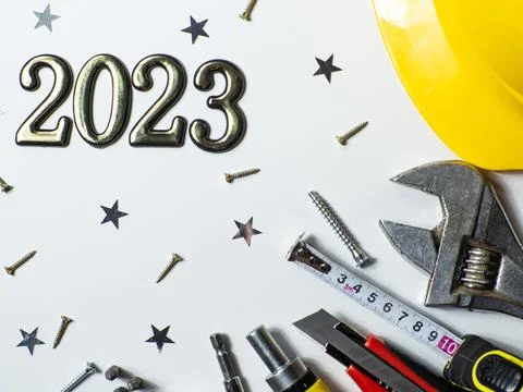 2023 with construction tools, hard hat on white background with copy space Foto stock