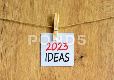 2023 Ideas symbol. White paper with words 2023 Ideas, clip on wooden ...