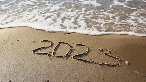 2023 year written on sandy beach sea. Stock Footage 220673556