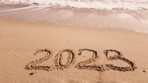 2023 year written on sandy beach sea at sunny day Video stock 233817017