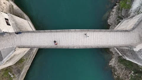 2024-03-19 Top-down ascending footage of people walking on Mostar Old Bridge Stock Footage 295606434