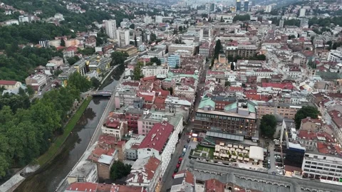 2024-06-22 Wide Rotating Aerial View of Sarajevo City and Hotel Europe Stock Footage 295040561