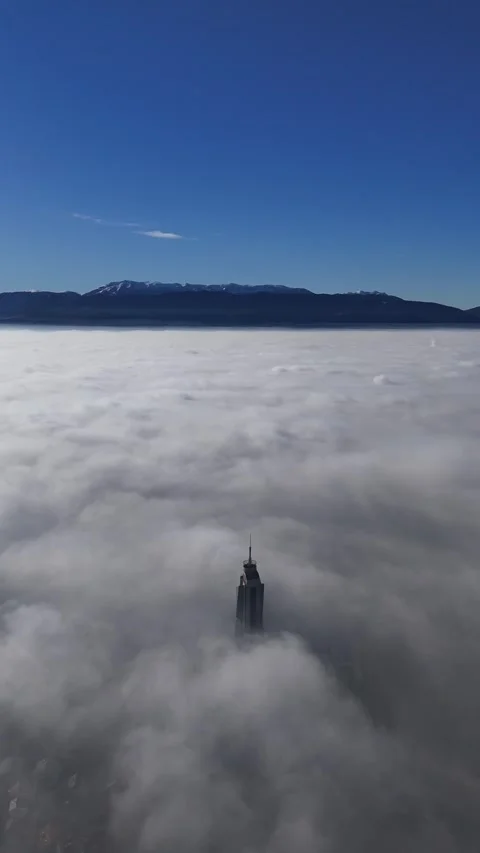 2024-12-17 Vertical Sarajevo Skyscraper Emerging from Dense Fog Stock Footage 296544677