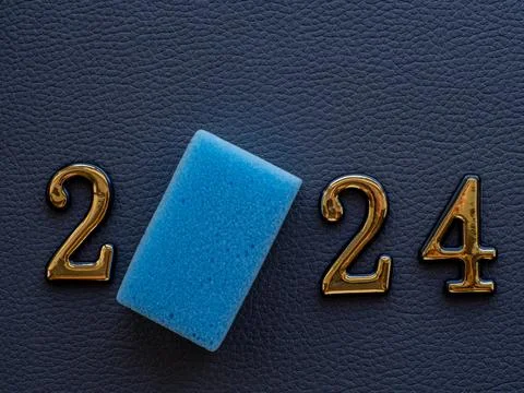 2024 and cleaning sponge instead zero on dark background Stock Photos