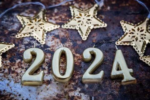 2024. Coming New Year. Numbers on rusty background with gold stars Stock Photos