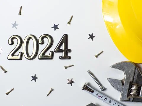 2024 with construction tools, hard hat on white background with copy space Stock Photos