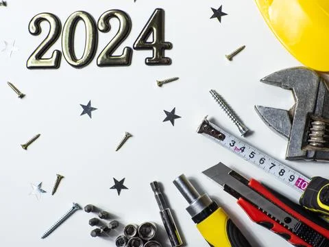 2024 with construction tools, hard hat on white background with copy space Stock Photos