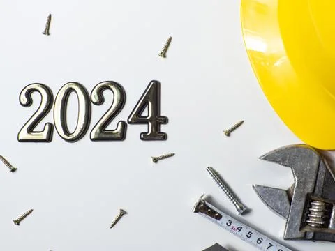 2024 with construction tools, hard hat on white background with copy space Stock Photos