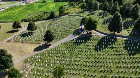 2024 July 11 - Forward Flyover Aerial Footage of Potocari Memorial Center Graves Stock Footage 294968285