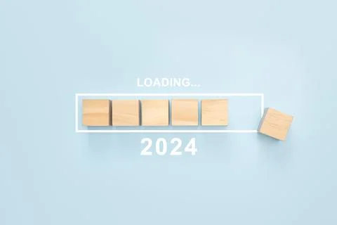 2024 New Year Loading. Loading bar with wooden blocks 2024 on blue background Stock Photos